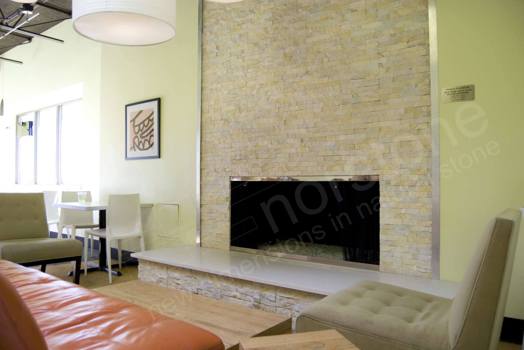Norstone Ivory Stacked Stone Rock Panels installed on a fireplace as part of a retail space build out